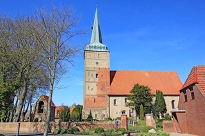 A historic building with a tall tower and a red-tiled roof.