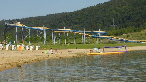 A water park with multiple slides and a sandy beach area. - Holiday Home Abertamy (Abertamy)