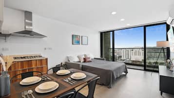 Deluxe Condo, Balcony, City View | Living area | TV