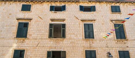 A historic building with multiple windows and a traditional stone facade.