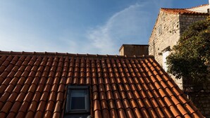 A building with a tiled roof and a small window. - Apartments Ivana Old Town -Superior Studio - APT2 (Dubrovnik)