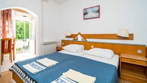 A hotel room with a bed, a nightstand, a chair, and a window with curtains. - Apartments Klis -Studio Apartment with Terrace - 2 (C) (Soline)