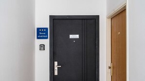 A black door with a "Marisol" sign, a "Partman" sign, and a keycard reader.