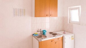 A small kitchen with a sink, stove, and cabinets. - Apartments Franka Saplunara-One-Bedroom Apartment with Terrace and Sea View No1 (Saplunara)