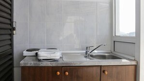 A kitchen with a built-in oven, a sink, and a window. - Lapad View Apartments - Studio Apartment with Balcony and Sea View (Dubrovnik)