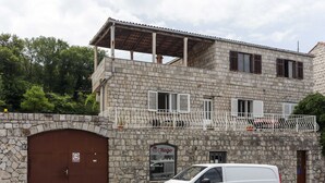 A stone building with a white van parked in front.