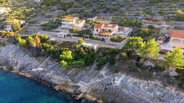 A coastal village with stone houses, clear blue sea, and rocky cliffs. - House Green Side Sunset- Four Bedroom House with Pool and Sea View (Prigradica)