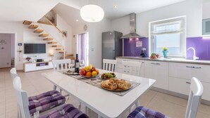 A modern kitchen with white cabinets, a built-in oven, and a large window. - Villa Blue Sky - Three Bedroom Villa with Pool (Bol)