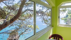 A room with a large window overlooking a body of water and trees. - Seafront Apartments Olivera-One Bedroom Apartment with Balcony and Sea View ( Ante ) (Blato)