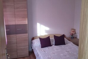 Comfortable room with a large wardrobe, bed, and nightstand, perfect for relaxing.