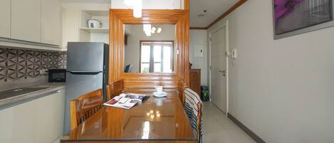 Una cocina moderna con una mesa de comedor de madera, un refrigerador y una isla de cocina.