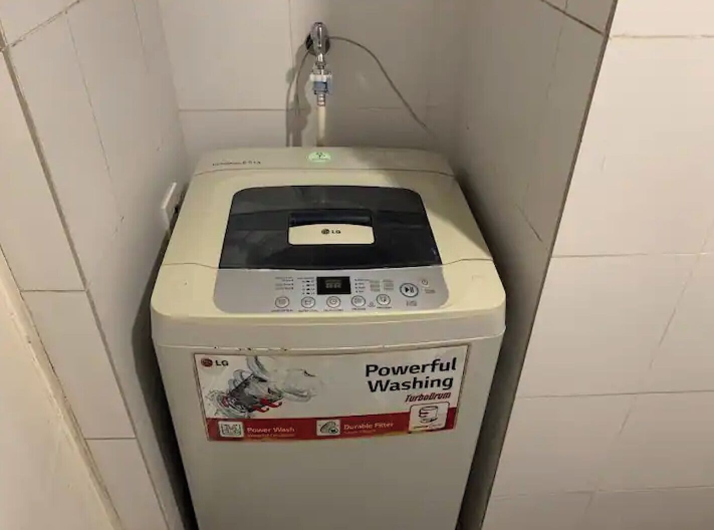 A compact, white LG washing machine with a control panel and a label that reads "Powerful Washing."