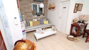 A living room with a sofa, coffee table, and decorative items.