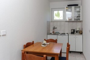 Enjoy meals in this well-equipped kitchen with a stove and dining table for four.