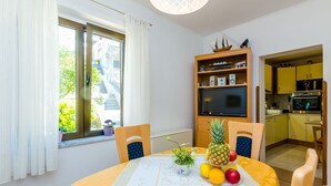 A compact kitchen with a microwave, oven, and yellow cabinets.