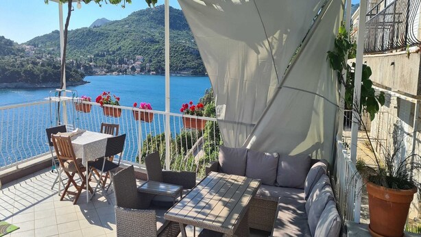 A terrace with wicker furniture, a sofa, and potted plants. - Apartments Matea - Studio with Sea View (2 Adults) - (Štikovica) (Stikovica)