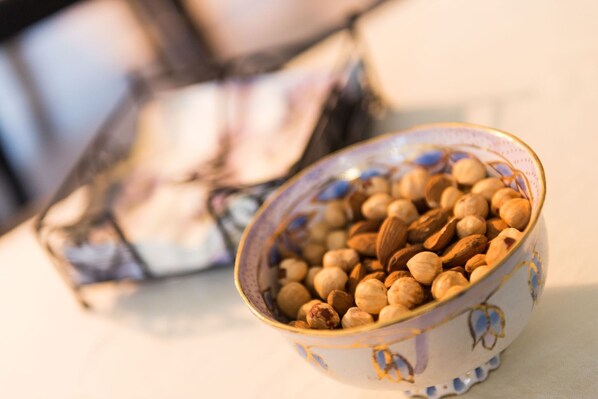 A bowl of nuts on a table with a blurred background. - Apartments Gaura - One-Bedroom Apartment with Terrace (Dubrovnik)