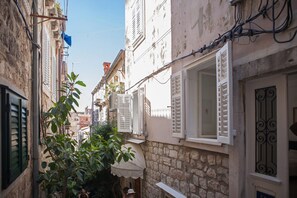 Stroll through this charming alleyway lined with traditional buildings featuring ornate balconies and windows.