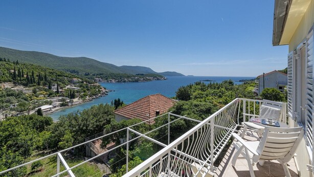 A balcony with a view of a coastal landscape, including a body of water and hills. - Guest House Rooms Rose- Comfort Double Room with Balcony and Sea View (Molunat)