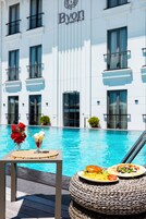 Vista de la piscina con una mesa de comedor, un postre y una fuente de comida.