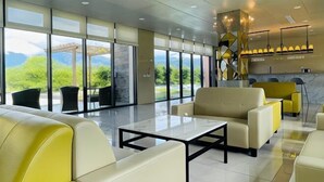 A modern lobby with a seating area, large windows, and a reception desk. - Mizuho Hotel (Hualien)