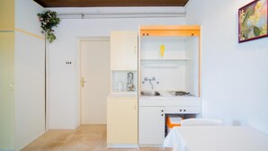 A compact kitchen with a sink, a small cabinet, and a countertop.