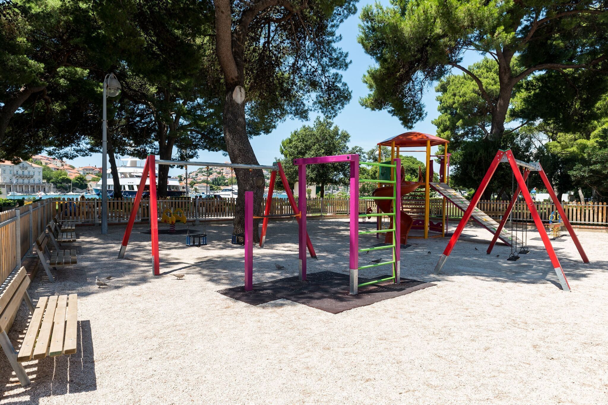 A playground with swings, a slide, and climbing structures.