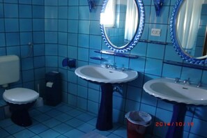 A bathroom with two sinks, a toilet, and a mirror with lights. - Villa Elit-Two Bedroom Apartment with Sea View Terrace ( A1) (Sumpetar)