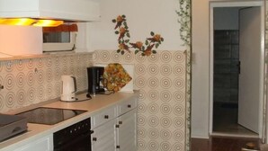 A kitchen with a microwave, coffee maker, and decorative flowers on the counter. - Villa Elit - Comfort Two Bedroom Apartment with Terrace ( A5) (Sumpetar)