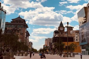 A city street with traditional and modern buildings, a clock tower, and a clear sky. - Beijing Bishui Lanxuan Hotel (Union Hospital Branch) (Beijing)