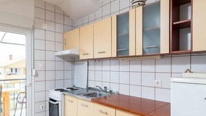 Cafetera o tetera, frigorífico, horno y placa de cocina