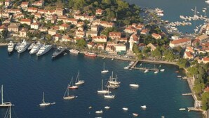 An aerial view of a coastal town with a marina filled with boats and yachts.