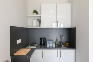Fridge, stovetop, electric kettle, dining tables