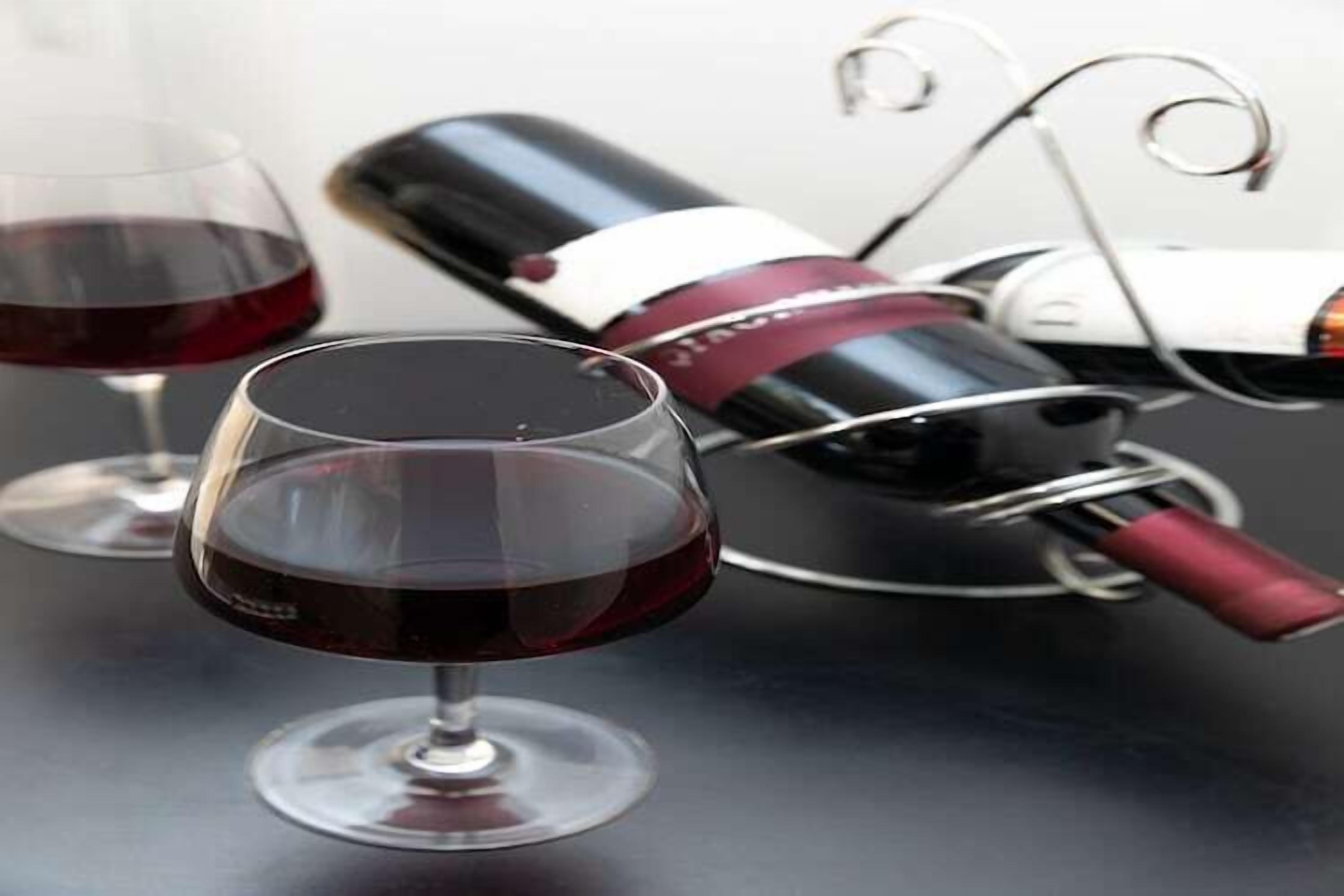 A wine bottle and two glasses on a table.