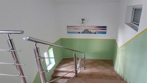 A staircase with metal railings and a green wall. - Apartments Smokvica - One Bedroom Apartment (Starigrad-Paklenica)