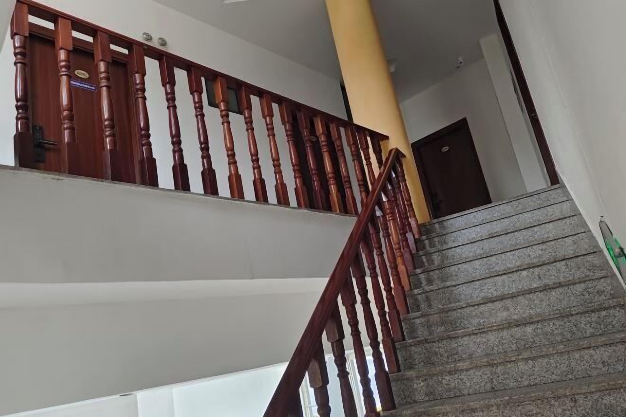 A staircase with wooden balusters and granite steps.
