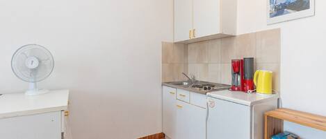 Fridge, stovetop, coffee/tea maker, dining tables