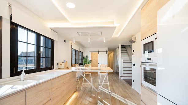 A modern kitchen with a central island, large windows, and a staircase leading to another level. - Country House 'Camino Blanco' with Private Pool, Shared Terrace and Air Conditioning (IBEAS DE JUARROS)
