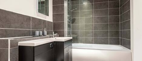 Shower, hair dryer, towels, shampoo
