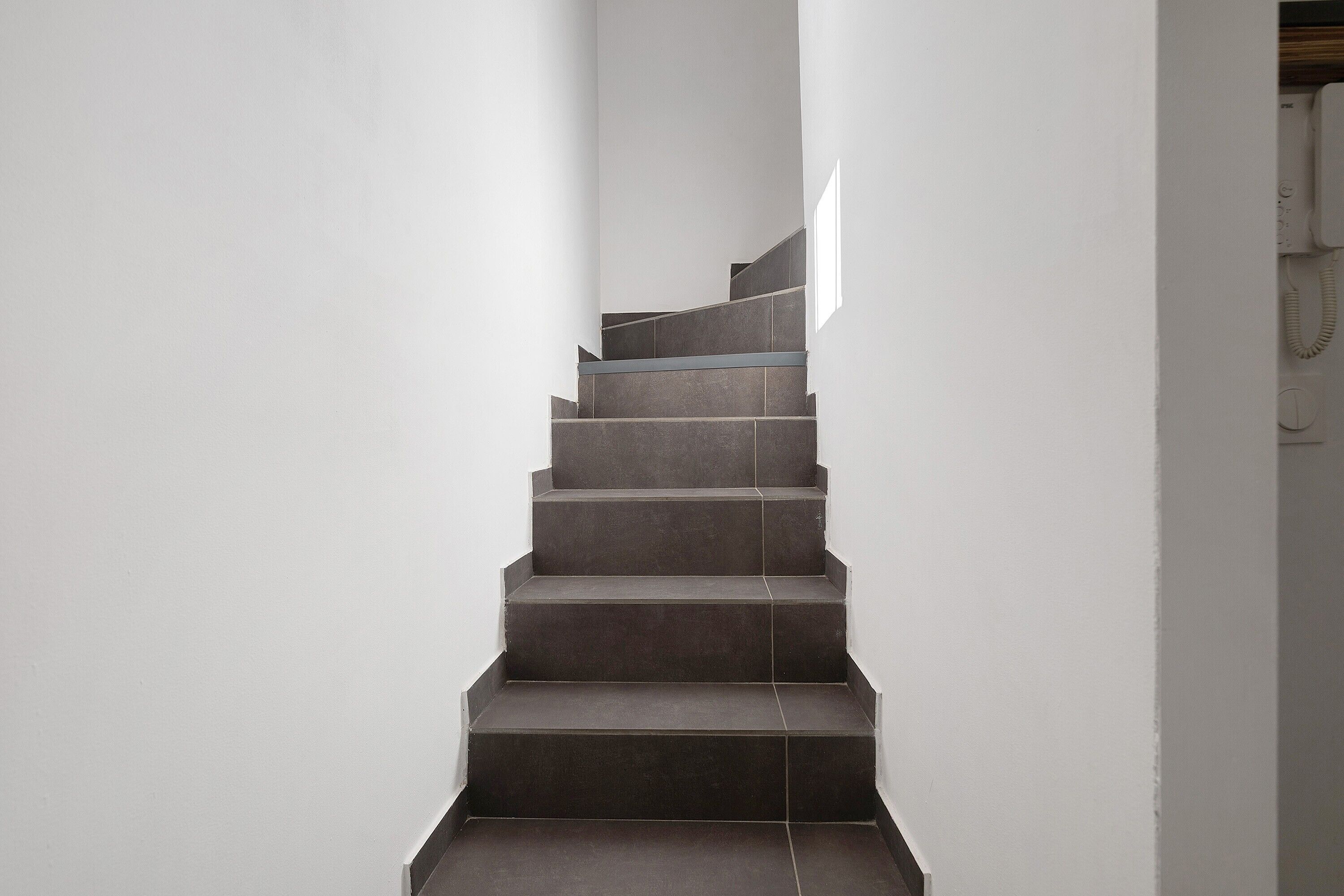 A staircase with a modern design, leading upwards.