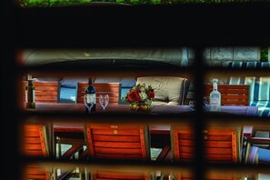 Experience a luxurious, intimate dining setting for two, complete with plush seating and a small table.