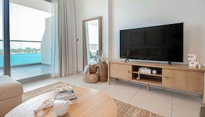 Deluxe Apartment, Balcony, Sea View | Living area | 55-inch Smart TV with cable channels