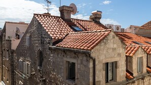 A traditional stone building with terracotta tiled roofs, multiple windows, and satellite dishes. - Apartments Urbis - Studio Apartment with City View (Zasebni) (Dubrovnik)
