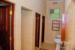 Comfort Triple Room | Bathroom | Shower, slippers, towels, soap - Shamba Hostel (Arusha)