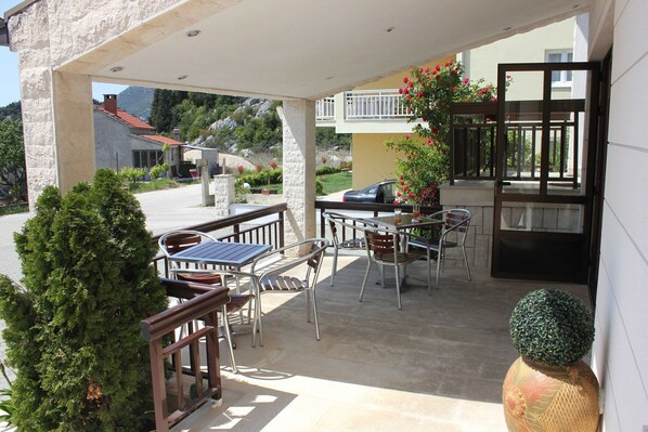 Relax in the serene outdoor patio, complete with comfortable seating and dining space.