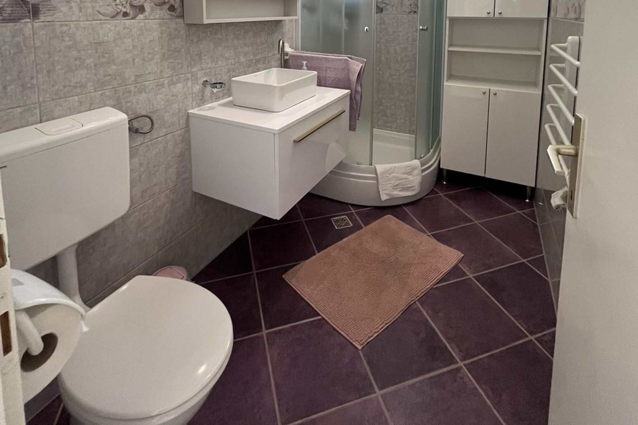 Un baño con inodoro, lavamanos y ducha.