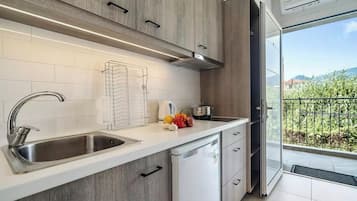 Junior Suite, Pool View | Private kitchen | Fridge, electric kettle, highchair