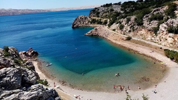 A coastal beach with rocky terrain and clear blue waters. - Apartment Villa Bijele Stijene - Two Bedroom Apartment with Terrace and Sea View (Karlobag)