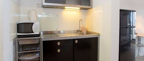 Fridge, microwave, stovetop, dining tables