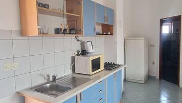Fridge, microwave, stovetop, dining tables
